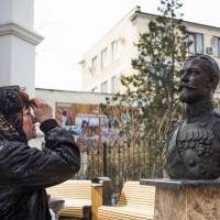 A woman prays at a bust of Russian Czar Nicholas II near the Crimean prosecutor’s office in Simferopol, Crimea on March 6. Russia's last czar still stirs controversy 100 years after abdication