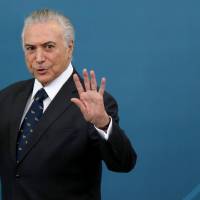Brazil’s President Michel Temer gestures during a ceremony at the Planalto Palace in Brasilia on March 7. 'Ghosts' drive Brazil president from residence, report says
