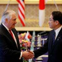 U.S. Secretary of State Rex Tillerson greets Foreign Minister Fumio Kishida on Thursday. Tillerson urged Japan to settle a diplomatic dispute with South Korea over so-called comfort women and focus on the North Korean threat. Tillerson calls for new approach on North Korea
