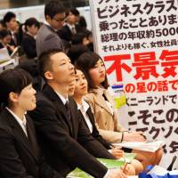 University students listen to a presentation as they attend a job fair at the Makuhari Messe convention center in Chiba Prefecture on March 1. Japan's 'Matrix'-style job fairs evolving as employers forced to think outside the square