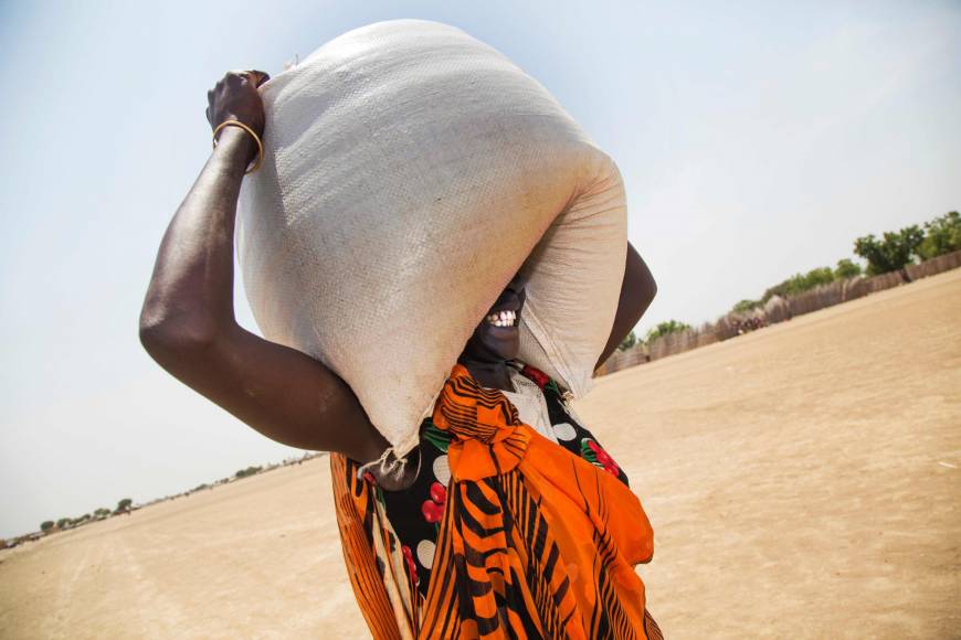 A woman carries a sack of food aid in Ganyiel, South Sudan on March 4.