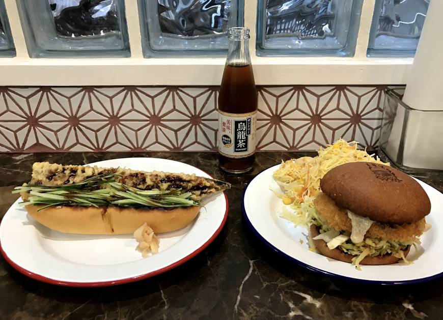 Delifucious Choose your weapon: An anago tempura dog (left) and a konbu-jime fish burger compete for attention at Delifucious in Nakameguro. | ROBBIE SWINNERTON