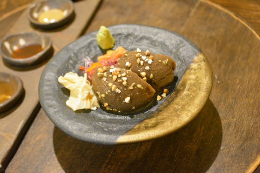 Gomachu Second to none: Tofu made with soba buckwheat and black sesame seeds and topped with roasted nuts is just one of the ways that Gomachu presents what can otherwise be a fairly staid staple. | J.J. O'DONOGHUE