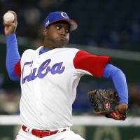 Cuba starting pitcher Vladimir Banos delivers during his team’s 6-0 win over China at Tokyo Dome in the World Baseball Classic on Wednesday. Cuba shrugs off fatigue to beat China at WBC