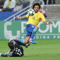 Brazil’s Marcelo scores against Paraguay during his team’s 3-0 win in a World Cup qualifier in Sao Paulo on Tuesday. Brazil punches ticket for World Cup