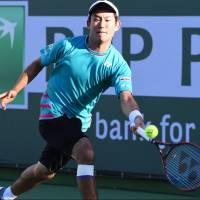 Yoshihito Nishioka plays a shot against Tomas Berdych in their third-round match at the BNP Paribas Open on Monday in Indian Wells, California. Nishioka prevails over Berdych, reaches BNP Paris Open fourth round