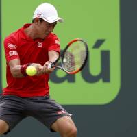 Kei Nishikori hits a return during his match against Fernando Verdasco at the Miami Open on Sunday. Nishikori turns back Verdasco to advance