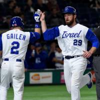 Israel’s Ike Davis (right) is congratulated by teammate Blake Gailen after arriving at home plate following a double by catcher Ryan Lavarnway during their World Baseball Classic second-round game against Cuba at Tokyo Dome on Sunday. Israel team turning heads at 2017 WBC