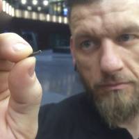 Self-described “body hacker” Jowan Osterlund from Biohax, Sweden, holds a small microchip implant, similar to those implanted into workers at the Epicenter digital innovation business center during a party at the co-working space in central Stockholm on March 14. Cyborgs at work: employees at Swedish startup getting implanted with microchips
