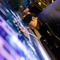 An attendee views an organic light-emitting diode screen at the 2017 Consumer Electronics Show in Las Vegas. Ahead of next iPhone, Idemitsu Kosan leads way after developing OLED screen