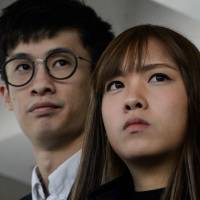 Pro-independence lawmakers Baggio Leung (left) and Yau Wai-ching speak to the media outside the High Court in Hong Kong in November. Pro-independence activists arrested in Hong Kong