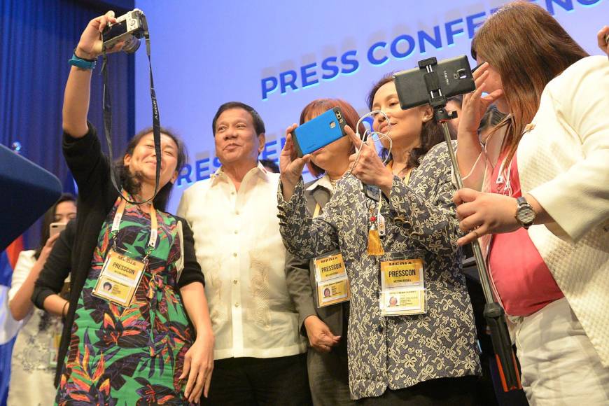 Philippine President Rodrigo Duterte poses for selfies with journalists after a news conference at the end of the ASEAN summit in Manila on Saturday. ASEAN gives Beijing a pass on South China Sea dispute, cites ‘improving cooperation’