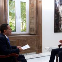 Syria’s President Bashar Assad (right) speaks during an interview with Venezuela’s Telesur channel, in this handout picture provided by SANA on Thursday. Assad looking to buy latest Russian anti-missile system to fend off Israeli, U.S. attacks