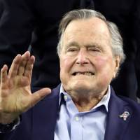 Former U.S. President George H.W. Bush arrives on the field to do the coin toss ahead of the start of Super Bowl LI between the New England Patriots and the Atlanta Falcons in Houston, Texas, U.S. on Feb. 5. He was hospitalized in Houston Tuesday. Ex-President George H.W. Bush hospitalized in Houston with pneumonia
