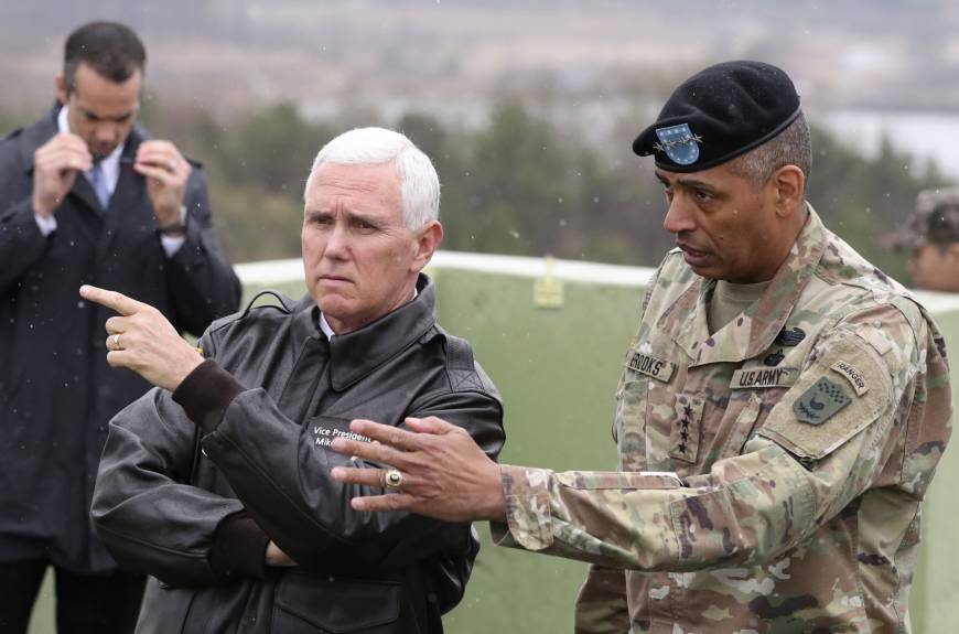 U.S. Vice President Mike Pence is briefed by Gen. Vincent Brooks, commander of the United Nations Command, U.S. Forces Korea and Combined Forces Command, from Observation Post Ouellette in the demilitarized zone (DMZ), near the border village of Panmunjom, South Korea, on Monday. Pence warns North Korea of U.S. resolve shown in Syria, Afghan strikes