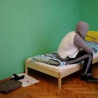 A Chechen gay man who fled persecution in his home, Russia’s Muslim region of Chechnya, due to his sexual-orientation sits on his bed in Moscow on Monday. Fearing death at hands of state, kin, gays flee Chechnya for hidden life in Moscow