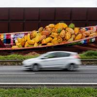 A car drives past part of the biggest mural in the world, by Brazilian artist Eduardo Kobra, in Itapevi on Wednesday. Brazilian street artist paints 'biggest' ever mural