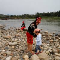 Ethnic Kachin people visit Myitsone, the confluence of the Mali and Nmai rivers, outside Myitkyina, Myanmar, on March 30. China may shelve controversial Myitsone dam in exchange for other interests in Myanmar