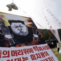North Korean defectors prepare to release balloons carrying leaflets and a banner denouncing North Korean leader Kim Jong Un after the country’s latest nuclear test, in Paju, South Korea, near the border with the North, in September. North Korea's avoidance of nuclear test could herald a return to diplomacy