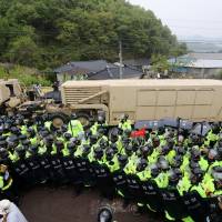 A U.S. military vehicle that is a part of the Terminal High Altitude Area Defense (THAAD) system arrives in Seongju, South Korea, on Wednesday. U.S. sends THAAD system to South Korean site in move blasted by presidential front-runner Moon