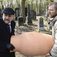 Chief Rabbi of Poland Michael Schudrich (left) and Rabbi Moshe Bloom carry a clay jar containing fragments of old Torah scrolls during a burial ceremony at the Jewish cemetery in Warsaw Wednesday. Warsaw’s Jewish community buried fragments of damaged Torah scrolls, performing the ancient ritual on the 74th anniversary of the start of the Warsaw Ghetto uprising, when about 750 Jews with few arms and no military training rose up on April 19, 1943, against a powerful German force that was about to send the ghetto’s last survivors to death camps. Jews revive ancient ritual on Warsaw ghetto uprising anniversary