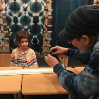 True blues: Oshi-san demonstrates the art of folding fabric to create and pattern during the aizome dyeing process. Japan's traditional blues for bright and cheery kids