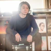 Vinyl revival: Chee Shimizu sits in front of a wall of albums at his home in Tokyo where he operates an online used record store. Hard-core vinyl fans are fueling a revival in obscure Japanese music from the 1980s