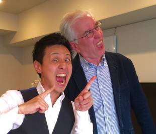 Kuninaga Osawa of the World Funny Face Association and Steve McClure make funny faces.