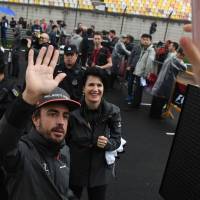 McLaren Honda driver Fernando Alonso waves to fans during an event in Shanghai on April 6, 2017. McLaren Honda puts F1 star Alonso in Indy 500 field