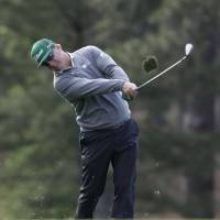 Charley Hoffman hits a shot from the fairway on the 17th hole during the first round of the Masters on Thursday. Hoffman has a four-shot lead. Hoffman fires 65 to lead Masters