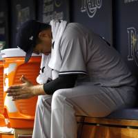 Masahiro Tanaka sits in the dugout after his season-opening outing against the Rays on Sunday in St. Petersburg, Florida. Tanaka, Yankees rocked in season opener