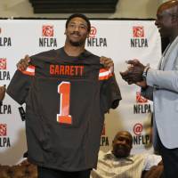 Defensive end Myles Garrett holds up a Cleveland Browns jersey as his mother Audrey cheers in Arlington, Texas, on Thursday after Garrett was selected as the No. 1 pick in the NFL Draft. Browns select Garrett with No. 1 pick in draft
