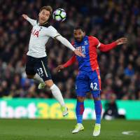 Tottenham’s Christian Eriksen (left) and Crystal Palace’s Jason Puncheon vie for the ball on Wednesday at Selhurst Park. Tottenham keeps title hopes alive with narrow victory