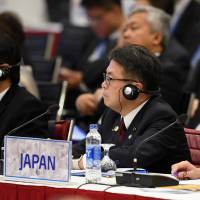 Trade minister Hiroshige Seko and his counterparts from the Asia-Pacific Economic Cooperation forum attend a meeting Saturday at the National Convention Center in Hanoi. APEC next to take up trade changes spurred by Trump