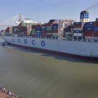 A crowd of well-wishers along River Street welcome the container ship COSCO Development Thursday morning in Savannah, Georgia, as the vessel sails up the Savannah River to the Port of Savannah. The ship is the largest vessel ever to call on the U.S. East Coast. East Coast ports scramble to accommodate largest container ship