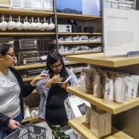Customers browse personal care products at a Muji store in New Delhi on Friday. Japan's no-brand retailer Muji predicts big expansion in India after China success