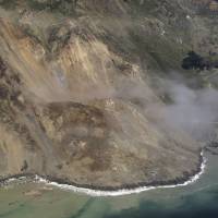This aerial photo taken Monday shows a massive landslide that has buried part of California’s coastal Highway 1. Massive landslide buries stretch of iconic California highway