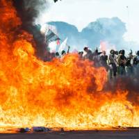 Demonstrators clash with the police during the protest ‘Occupy Brasilia’ against the labor and social security reforms of the government in Brasilia on Wednesday. Embattled Brazilian president sends out troops as protests rage