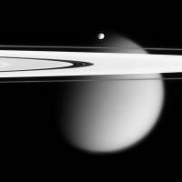 This image made by the Cassini spacecraft in 2006 shows two of Saturn’s moons, the small Epimetheus and smog-enshrouded Titan, with Saturn’s A and F rings stretching across the frame. Launched in 1997, Cassini reached Saturn in 2004 and has been exploring it from orbit ever since. Cassini probe finds vast void between Saturn's rings