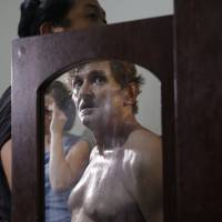 Suspected child webcam cybersex operator David Timothy Deakin, from Peoria, Illinois, is reflected in a mirror as investigators gather evidence during a raid at his home in Mabalacat, Philippines, in April 20. Massive child webcam sex bust in Philippines reveals rising abuse worldwide