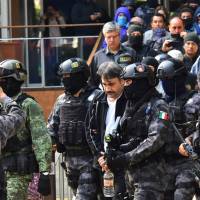 Mexican soldiers and agents from the Criminal Investigation Agency escort Damaso Lopez, a senior lieutenant in the Sinaloa crime syndicate of jailed drug lord Joaquin “El Chapo” Guzman, after arresting him in Mexico City on Tuesday. Mexico captures drug kingpin Lopez, former protege of 'El Chapo'