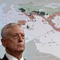 U.S. Defense Secretary Jim Mattis stands in front of a map of Syria and Iraq during a news conference at the Pentagon on Friday. U.S. pitches plan to Russia to avoid armed conflict in Syria