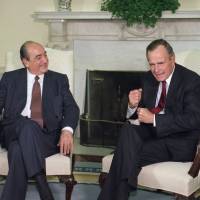 U.S. President George H.W. Bush gestures in 1992 with clenched fists during a meeting with Greek Prime Minister Constantine Mitsotakis in the Oval Office of the White House in Washington. Mitsotakis’ family has put out a short statement saying he died Monday “surrounded by those whom he loved and who loved him.” He was 98. Conservative ex-Greek leader Mitsotakis dead at 98