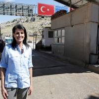 U.S. Ambassador to the United Nations Nikki Haley poses at a border gate with Syria in the Turkish border town of Reyhanli, in the southern Hatay province, Turkey, Wednesday. On the Syrian-Turkey border, Haley confronts civil war's reality