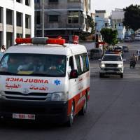 Hamas police secure the area as an ambulance reportedly carrying the bodies of three executed men accused of assassinating one of its military leaders leaves the main police building in Gaza City on Thursday. Hamas executes three Palestinians over killing it says was ordered by Israel