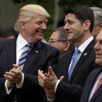 President Donald Trump talks to House Speaker Paul Ryan in the Rose Garden of the White House in Washington Thursday after the House pushed through a health care bill. Trump happy as House passes GOP health bill in step toward Obamacare repeal