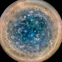 This NASA handout image released Thursday shows Jupiter’s south pole, as seen by NASA’s Juno spacecraft from an altitude of 32,000 miles (52,000 kms). The oval features are cyclones, up to 600 miles in diameter. Multiple images taken with the JunoCam instrument on three separate orbits were combined to show all areas in daylight, enhanced color, and stereographic projection. NASA's Juno probe spots monstrous cyclones churning over Jupiter's poles