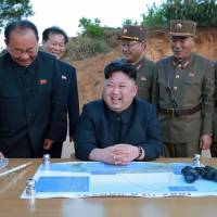 North Korean leader Kim Jong Un celebrates the test launch of the long-range strategic ballistic rocket Hwasong-12 with Ri Pyong Chol (second from left), Kim Jong Sik (center) and Jang Chang Ha (second from right) in this undated photo released by state media on May 15. Kim's rocket stars: the trio behind North Korea's missile program