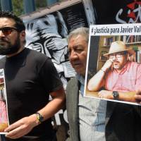 Journalists show pictures of Mexican journalist Javier Valdez, murdered Monday, during a protest by journalists in Mexico City on Tuesday. Mexico ranks third in the world for the number of journalists killed, after Syria and Afghanistan, according to media rights group Reporters Without Borders (RSF). Mexicans demand justice after brazen murder of prominent reporter, the fifth this year