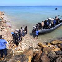 Illegal migrants from Africa arrive on shore after being rescued by the Libyan coast guard off the coastal town of Tajoura, 15 km east of the capital Tripoli on Tuesday. Dozens on sinking dinghy lost at sea, rescued migrants tell UNHCR
